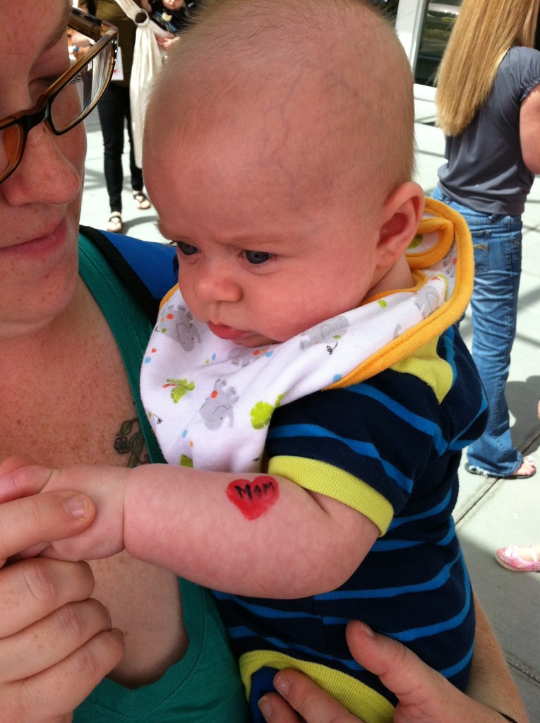 Aunt Bree holds Atticus just after he got his first "tattoo" (everyone else getting their faces painted)