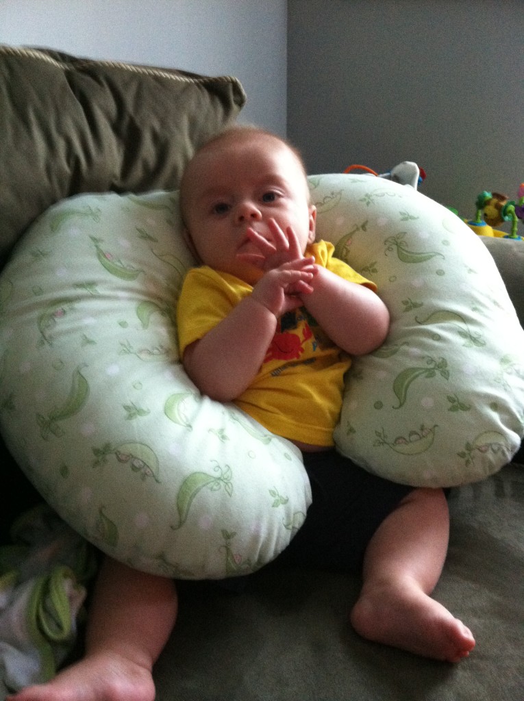 Atticus lounges on the couch, casually flashing gang signs